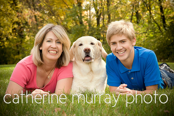 A mom and teenage son posing with their yellow lab