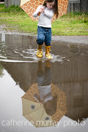 Young Girl Playing in the Puddles